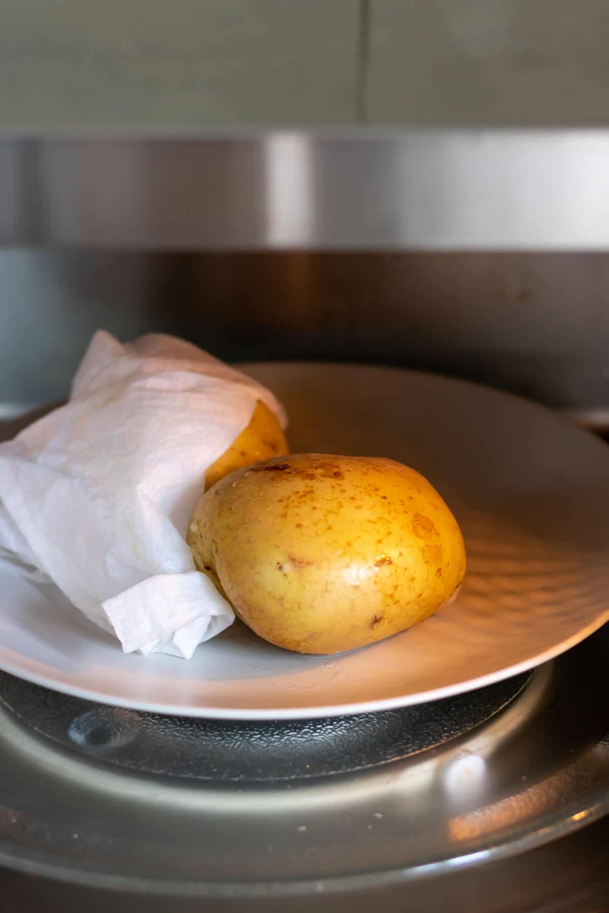 Potatoes cooking in a microwave.