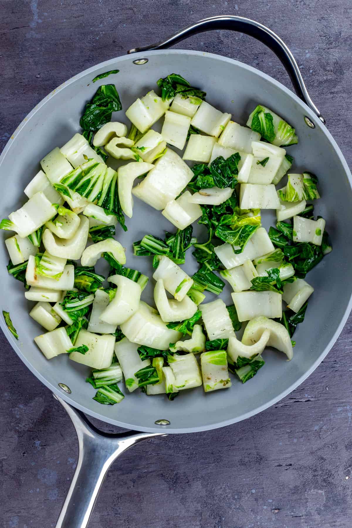 Cooked bok choy in a skillet.
