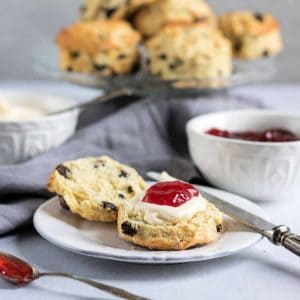 Cut open scone with cream and jam.