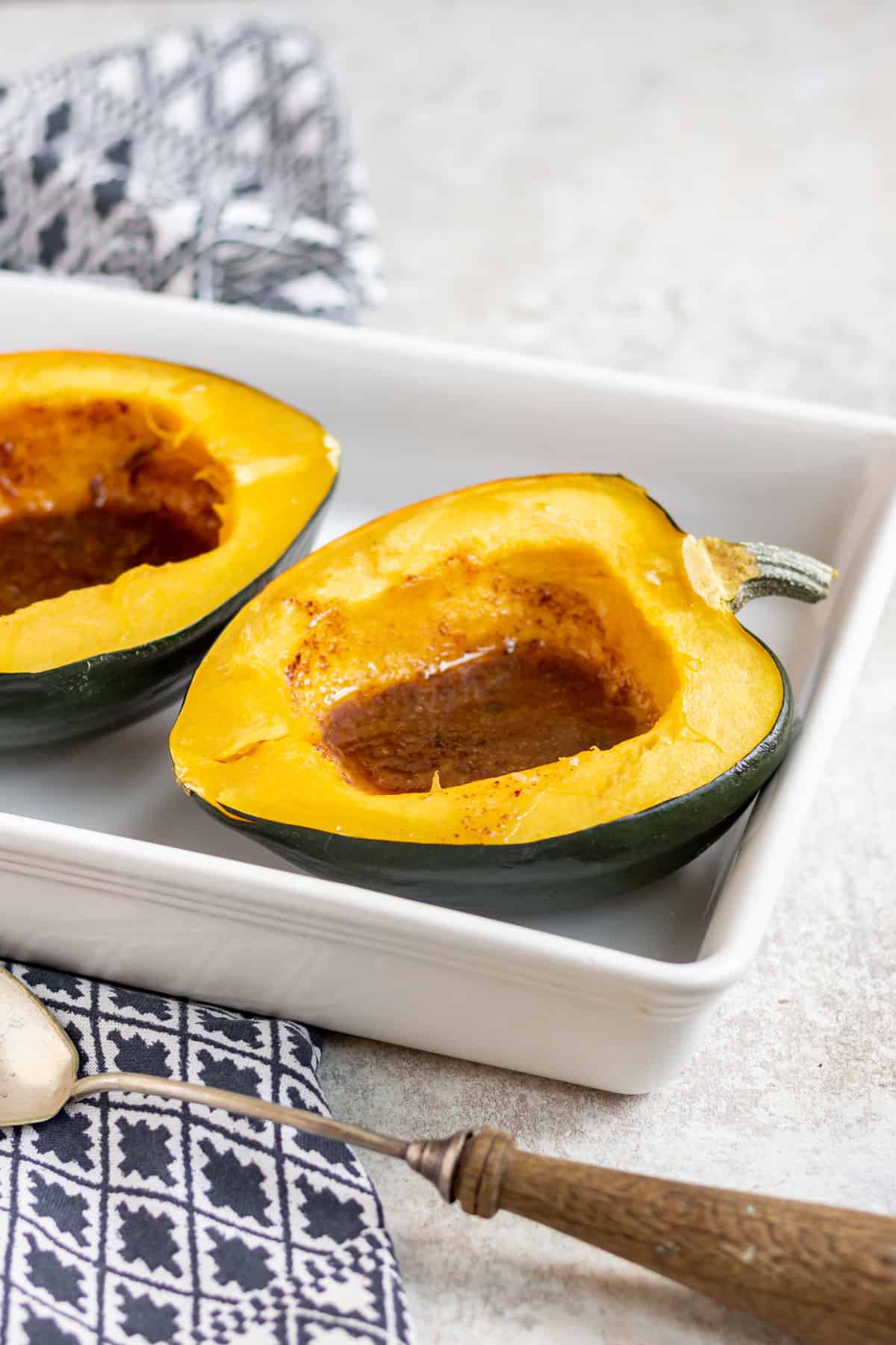 Acorn squash halves filled with brown sugar and butter.