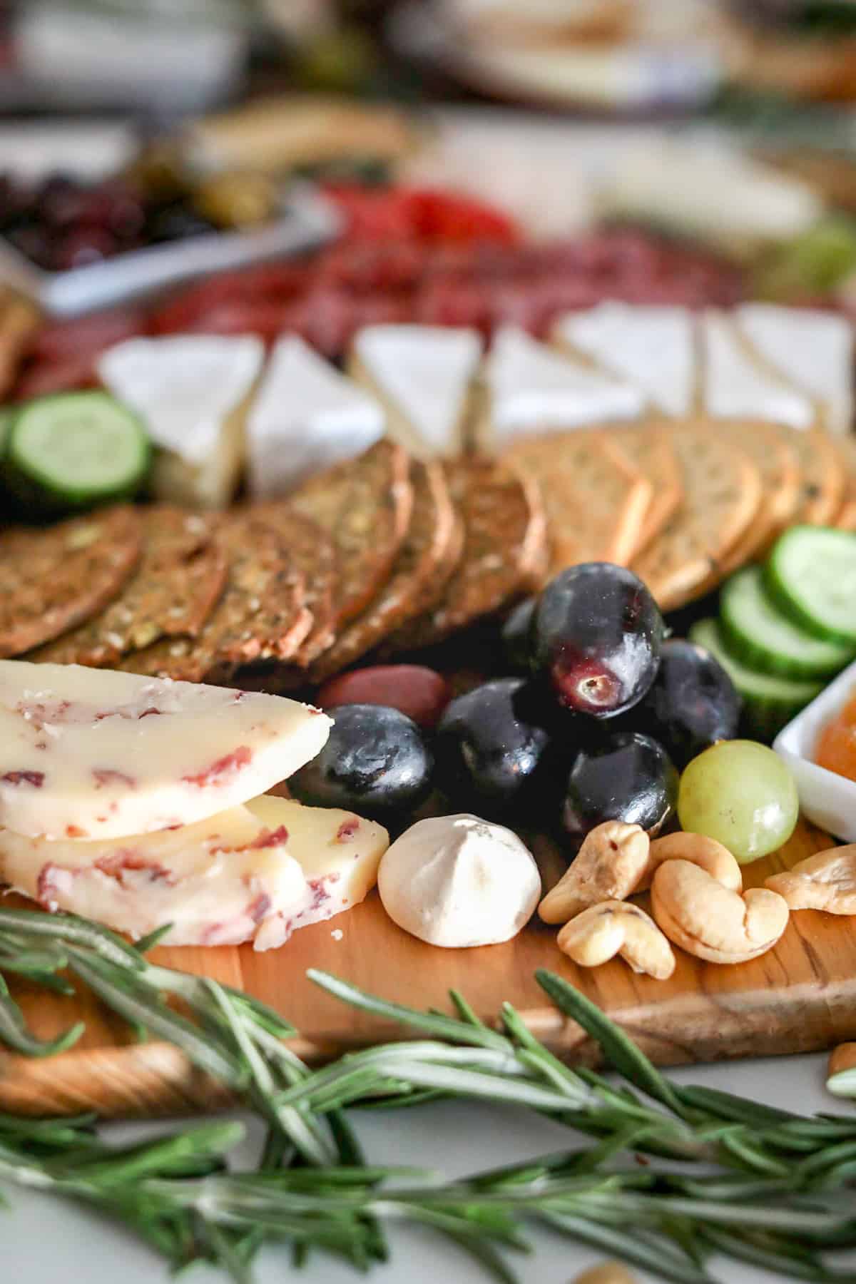 Meats, cheeses and nuts on a board.