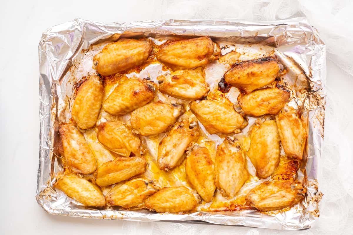 Baked wings on a baking sheet.