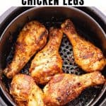 Air fryer with cooked drumsticks, with text: Quick air fryer chicken legs.