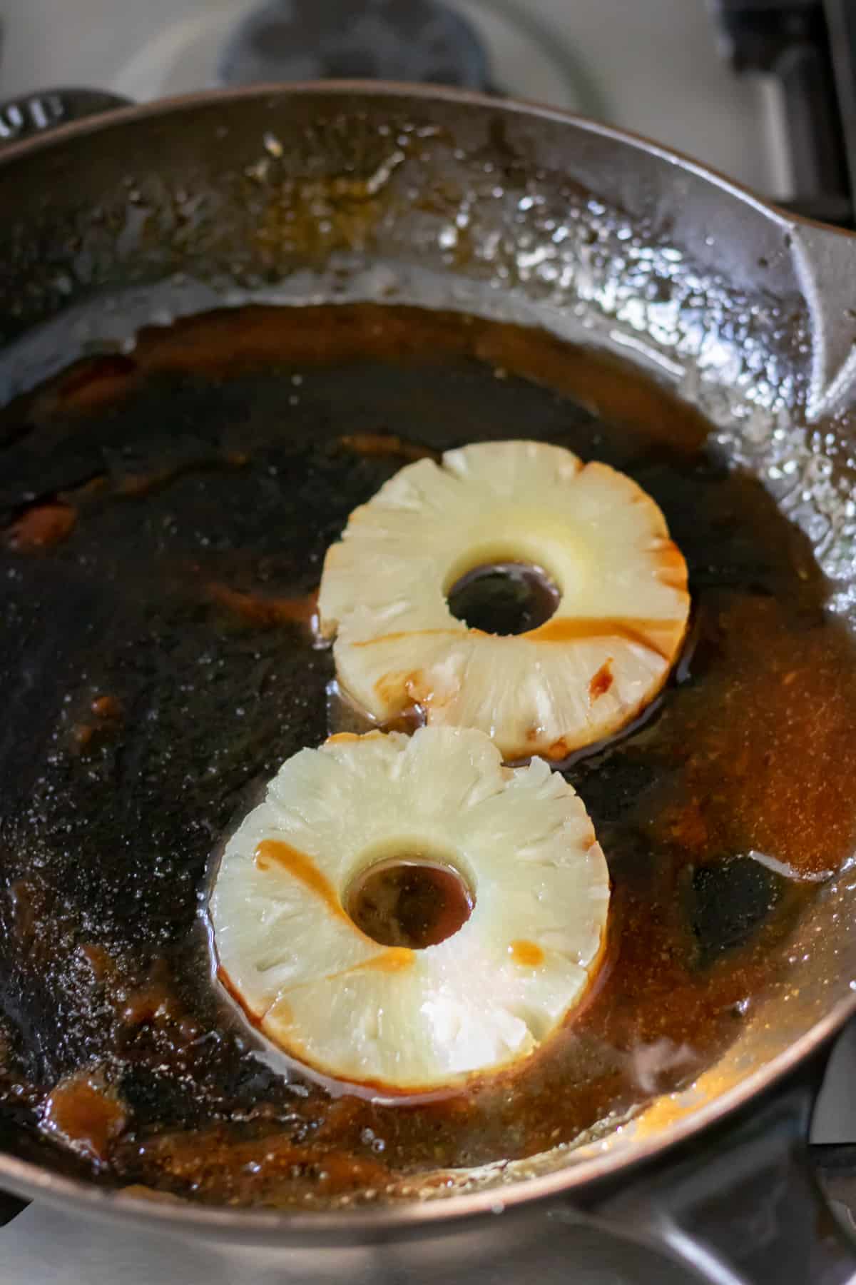 Pineapple rings added to the pan of glaze.