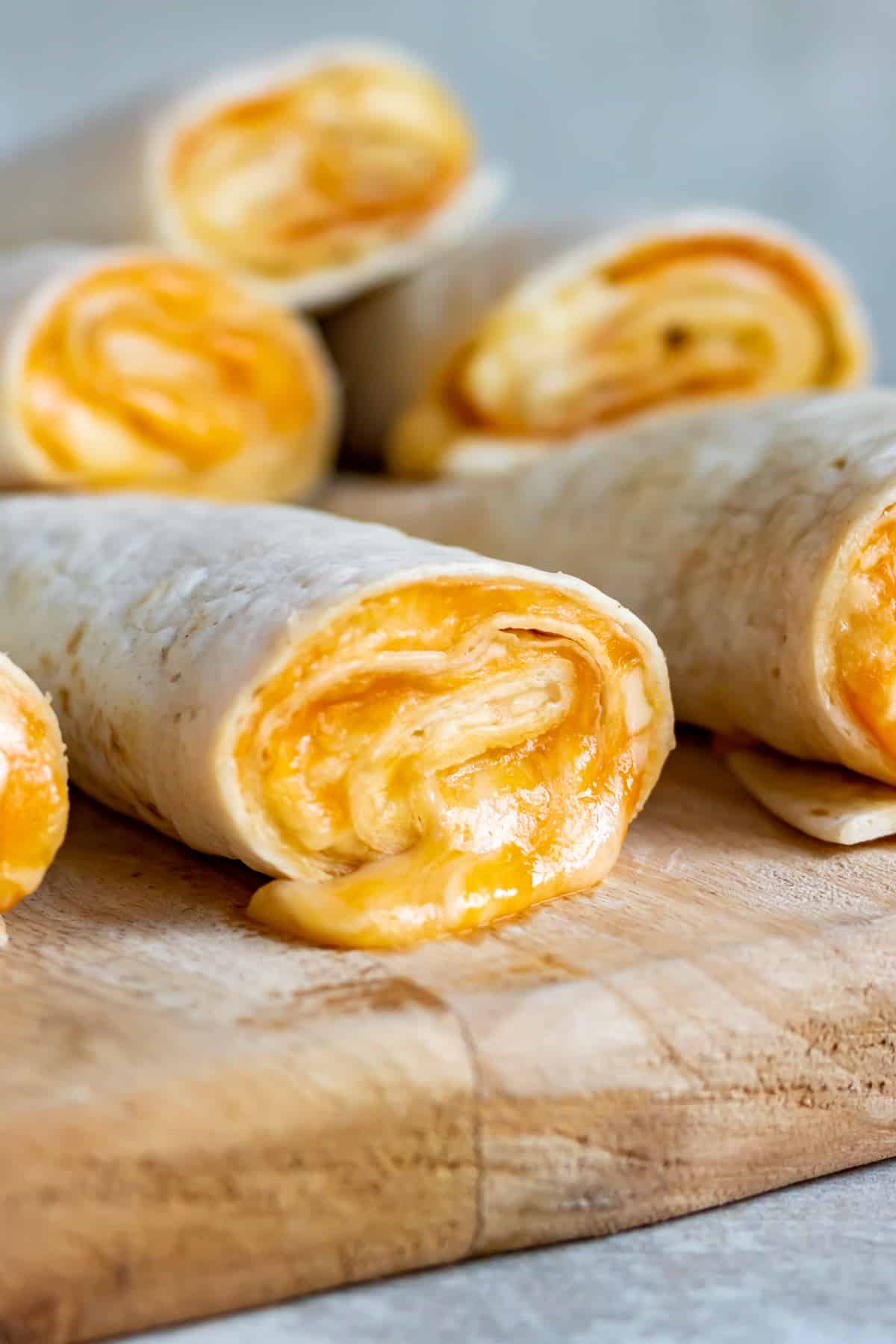 Close up of cheese oozing out of a melted Taco Bell Cheese Roll Up.