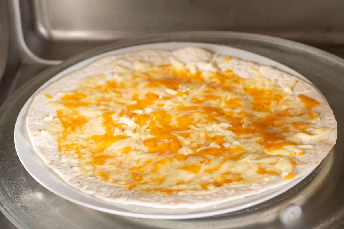 Melted cheese on a tortilla.