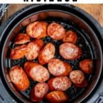 An air fryer full of smoked sausage, with text: Air Fryer Kielbasa.