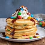 Close up of a stack of m and m pancakes.