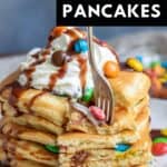 A fork in a bite of pancakes, with text: M&M Pancakes.