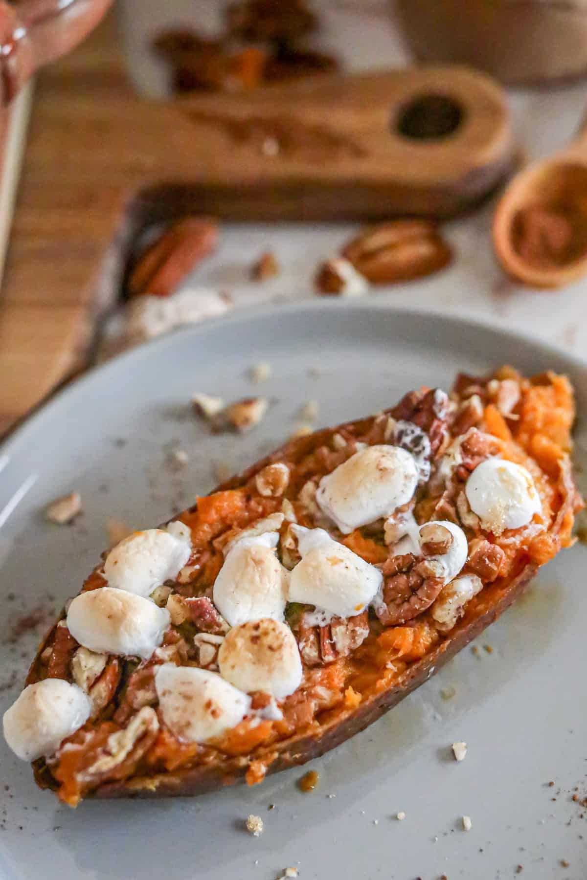 Close up of a sweet potato topped with mini marshmallows.