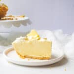 Slice of lemonade pie on a plate.