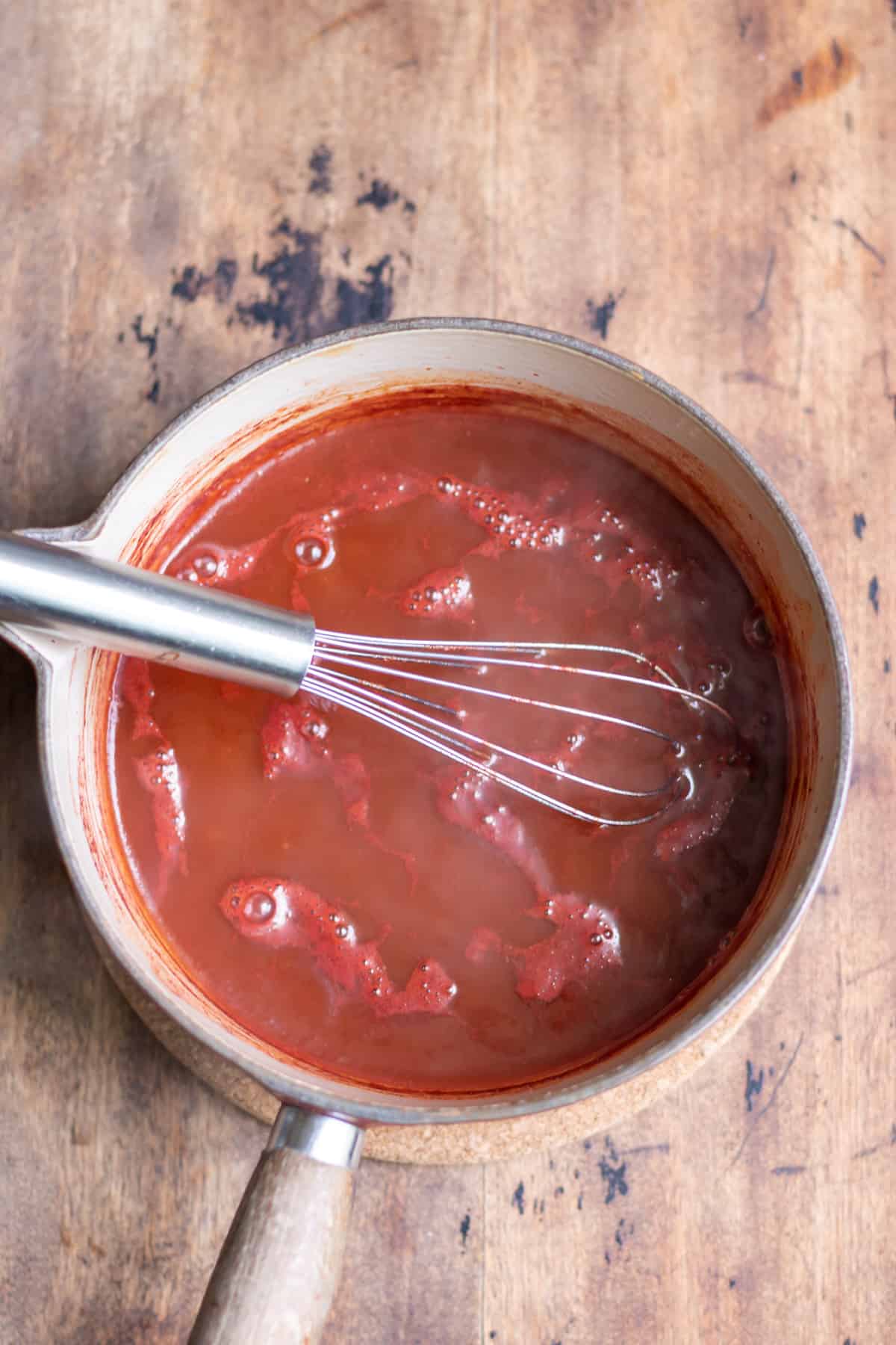 Whisking the hot sauce.