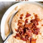 Spoon in a bowl of dip, with text: Easy Bacon and Garlic Aioli.