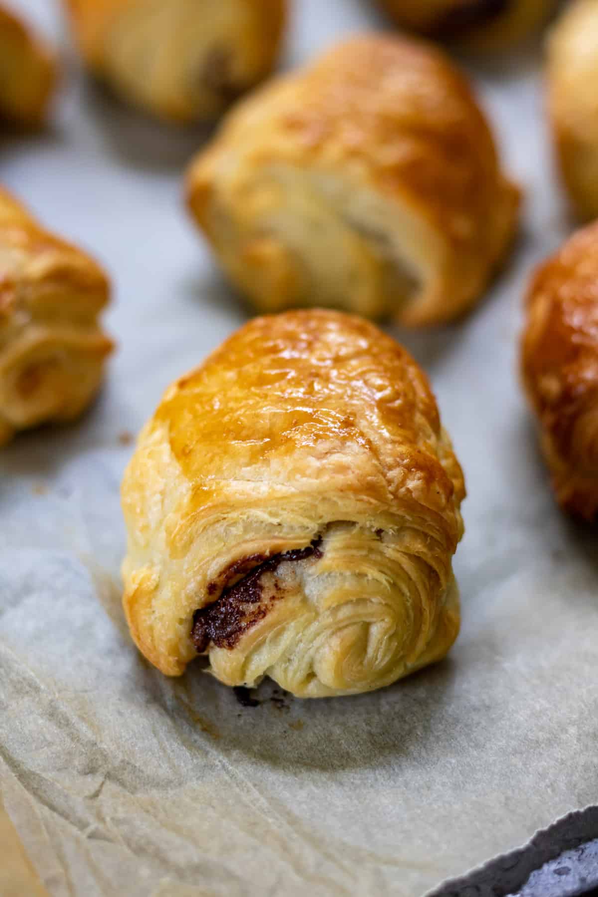 Close up of a mini chocolate pastry roll bite.