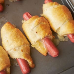 Row of cooked crescent dogs.