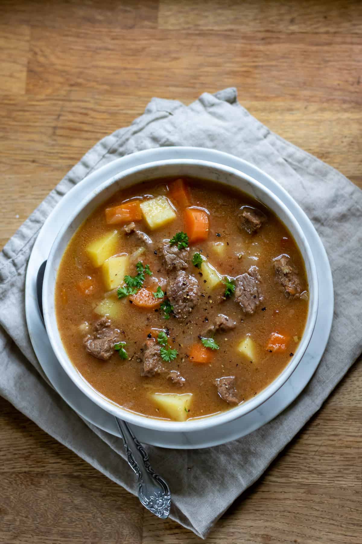 Table with a bowl of Irish beef stew.