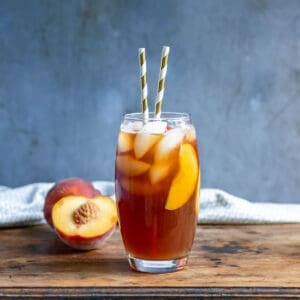 Glass of iced tea with peaches.