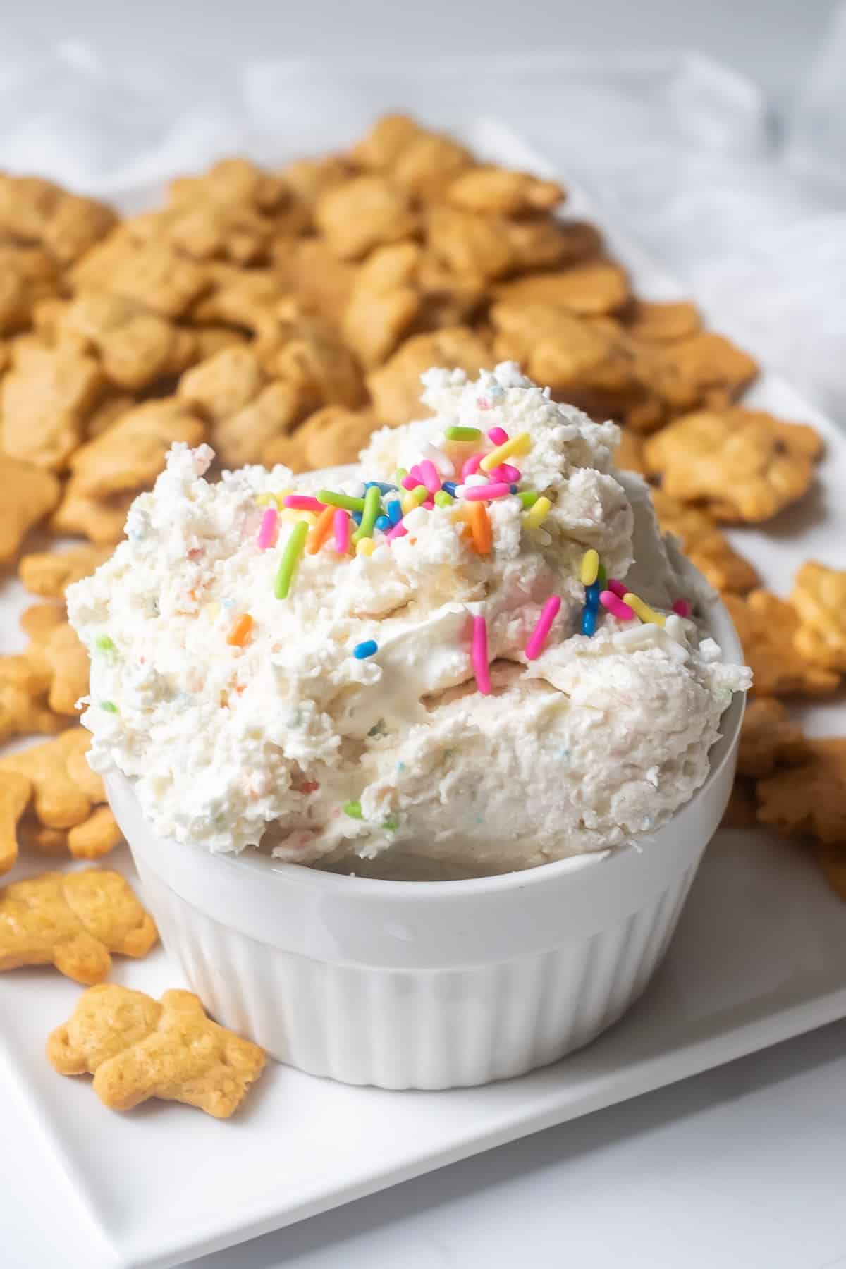 Close up of a bowl of dunkaroo dip with sprinkles.