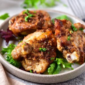 Plate of parmesan chicken thighs.