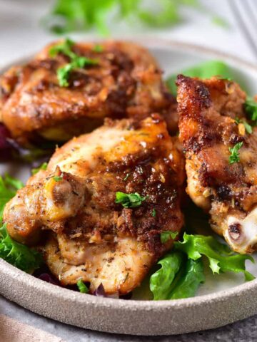 Plate of parmesan chicken thighs.