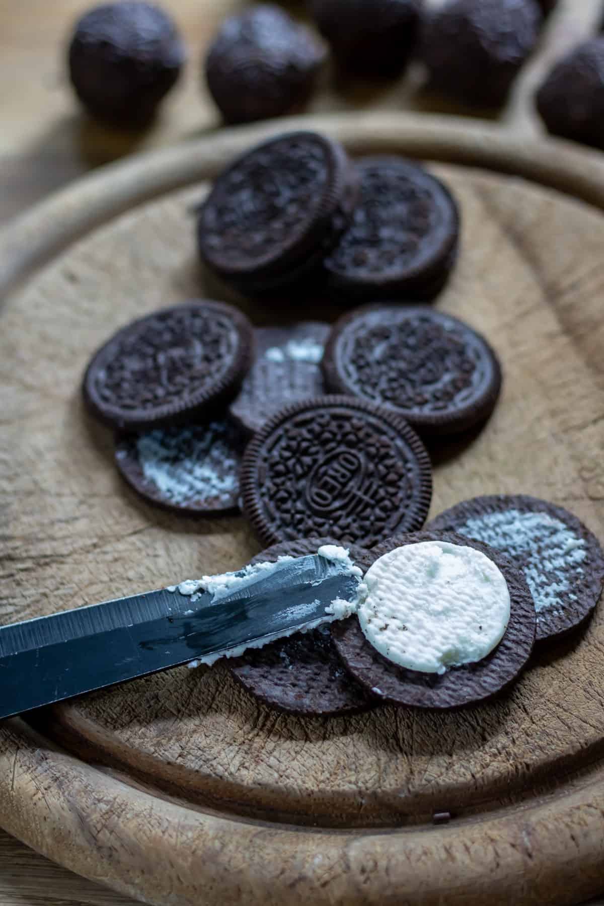 Scraping the filling out of oreos.