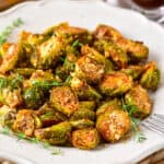 Close up of parmesan brussels sprouts on a serving dish.