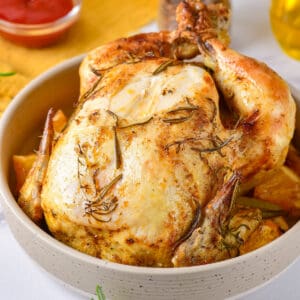 Serving dish with a whole roasted chicken.