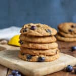Stack of lemon blueberry cookies on a wooden board.