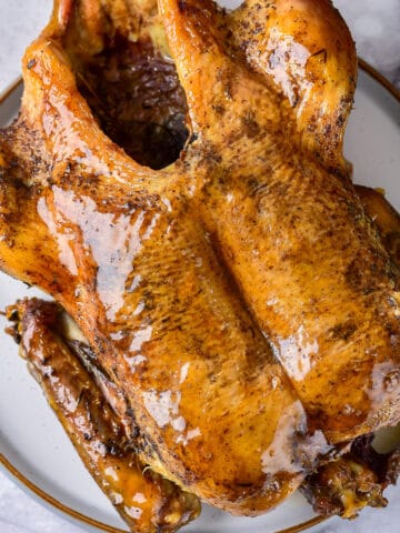 Close up of a glazed roasted duck.