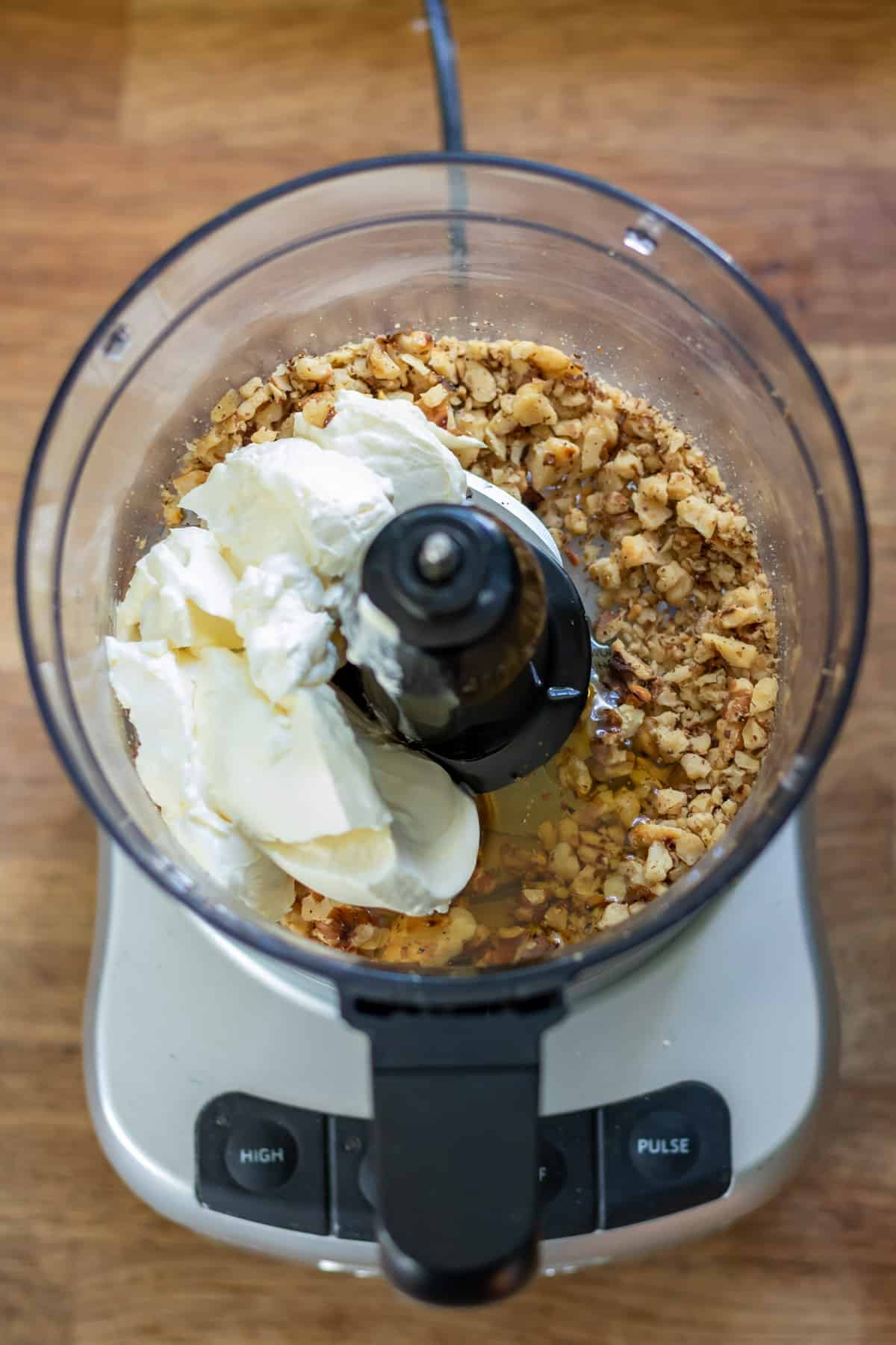 Cream cheese, honey, vanilla and salt added to the walnuts in the food processor.