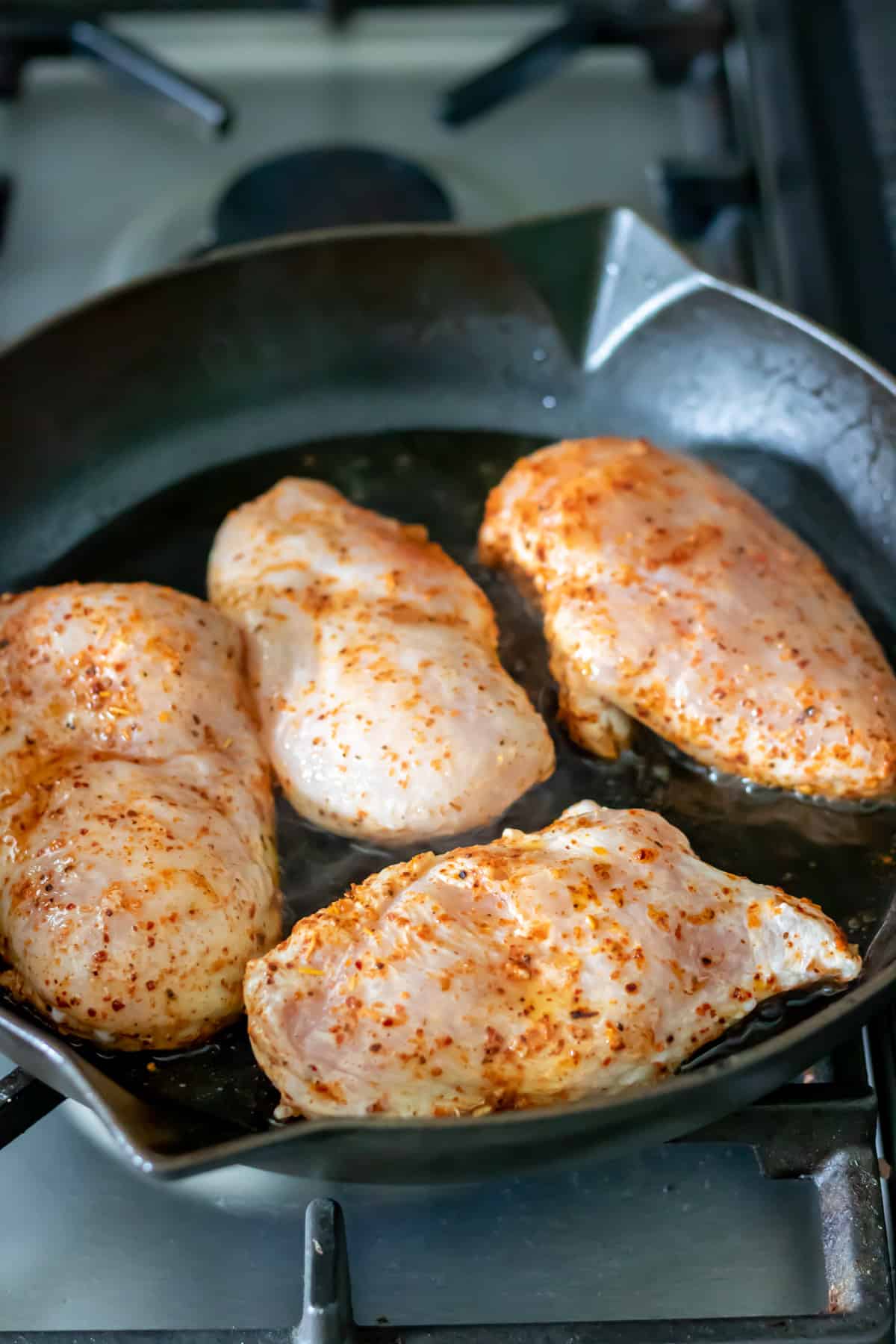 Pan frying chicken breasts.