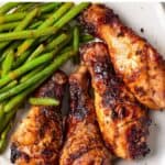 Plate of chicken with text: Air fryer or oven baked honey mustard chicken legs.