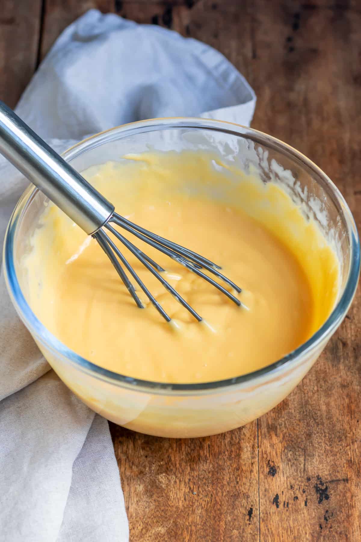 Whisk in a bowl of cheese sauce.