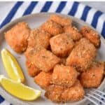 Plate of breaded salmon cubes, with text: Air fryer or oven baked breaded salmon bites.