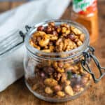 Jar of roasted tajin nuts on a table.