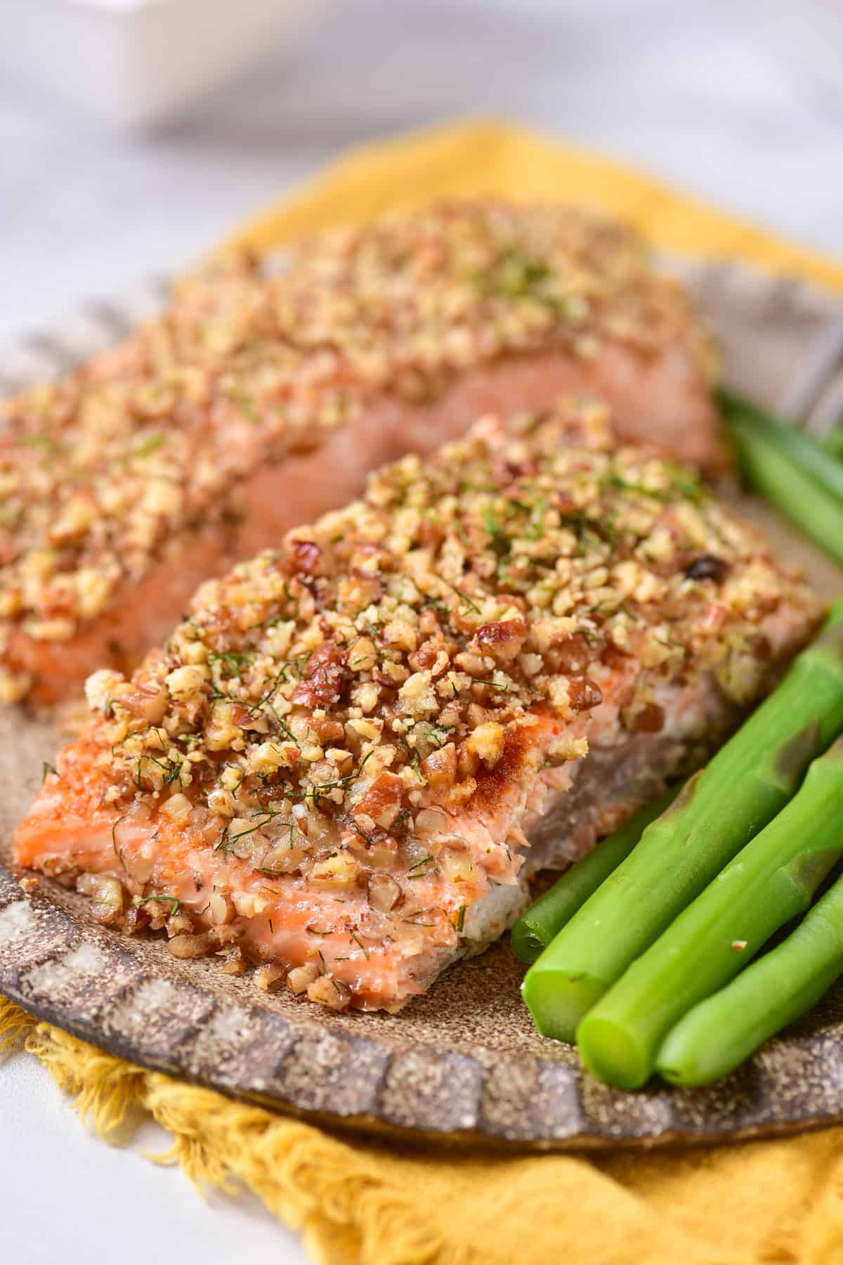 Close up of a fillet of salmon with a pecan crust.