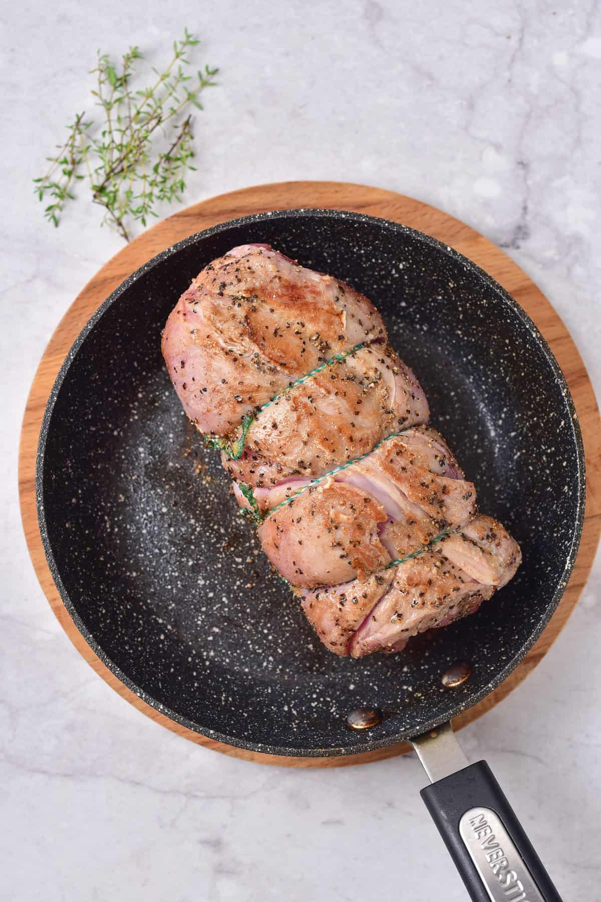 Pan searing rolled lamb.