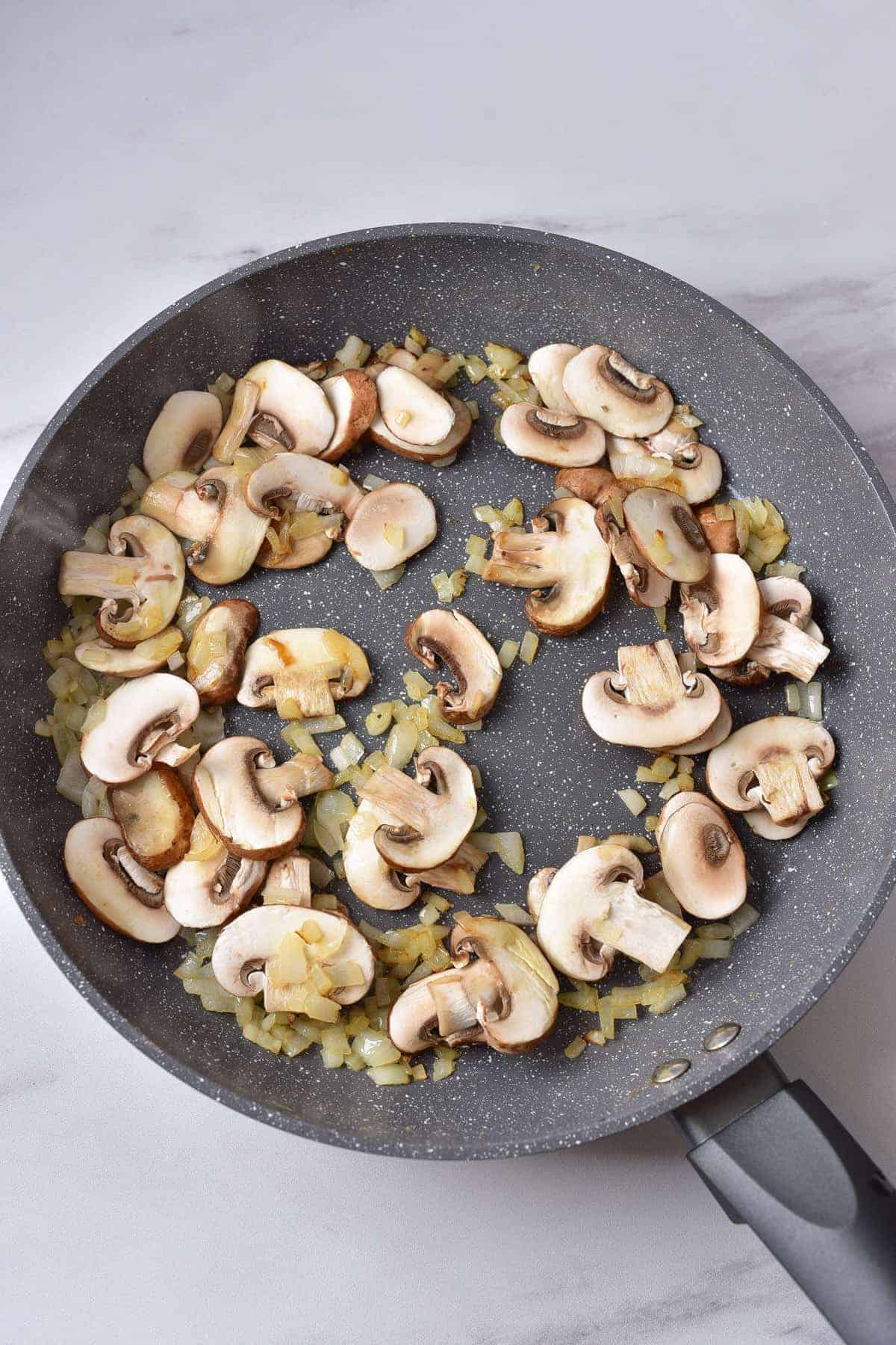 Cooking onion and mushrooms.