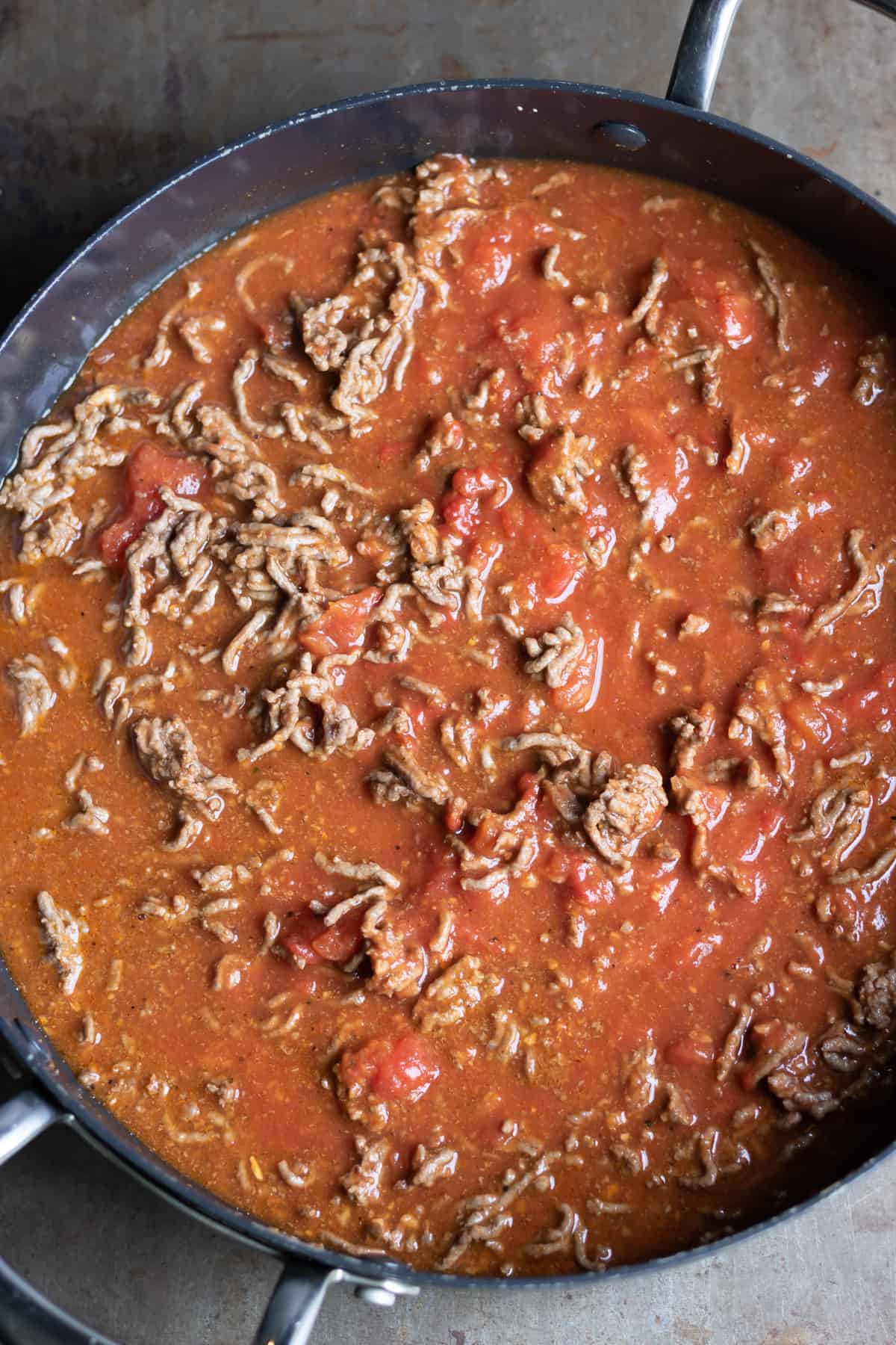 Beef simmering in tomato sauce.