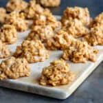 Side view of cornflake cookies on a wooden board.
