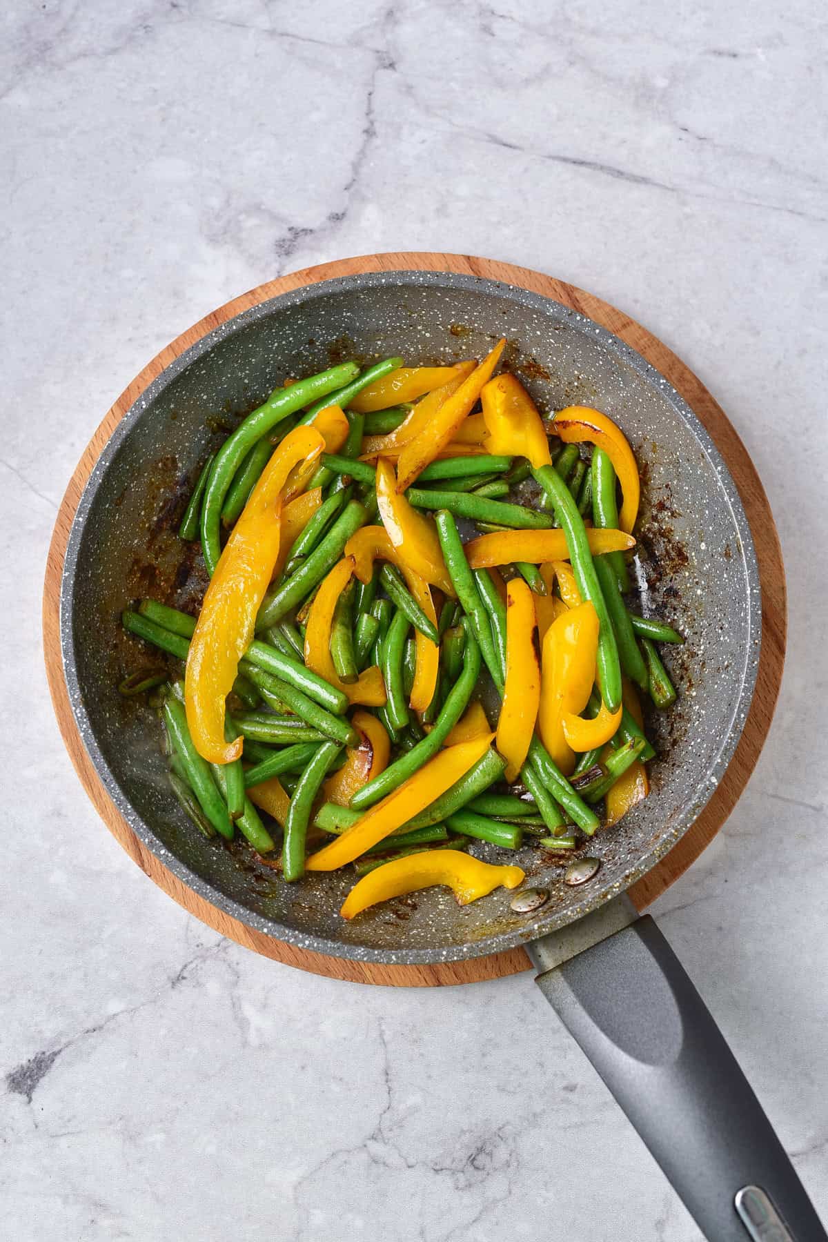 Sauteeing the green beans and bell peppers.