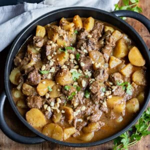 A dish of Slow Cooker Beef Massaman Curry on a table.