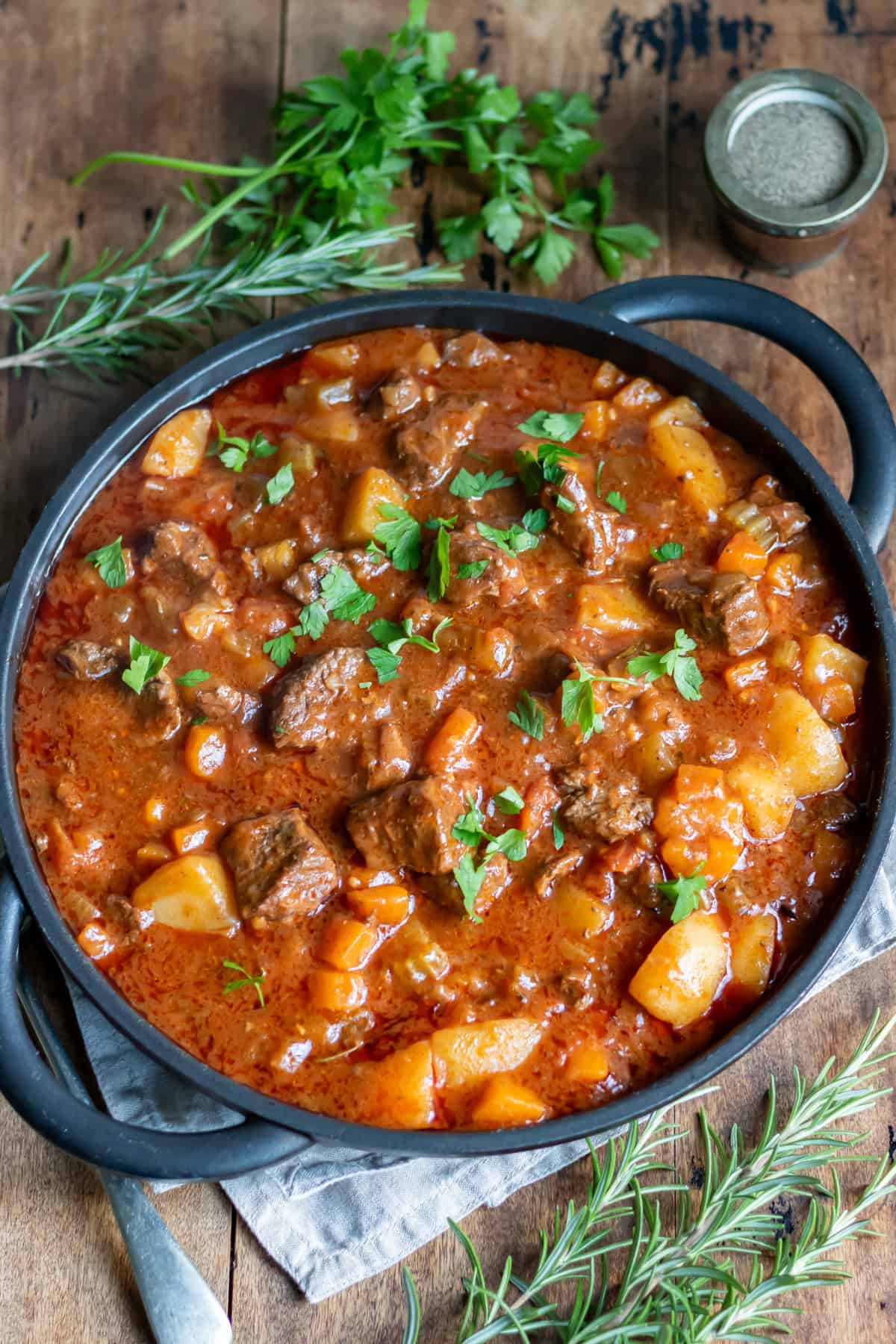 Serving dish of spezzatino Italian beef stew on a table.