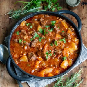 Serving dish of spezzatino Italian beef stew on a table.