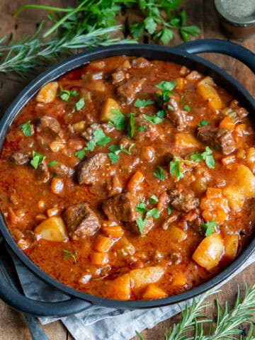Serving dish of spezzatino Italian beef stew on a table.