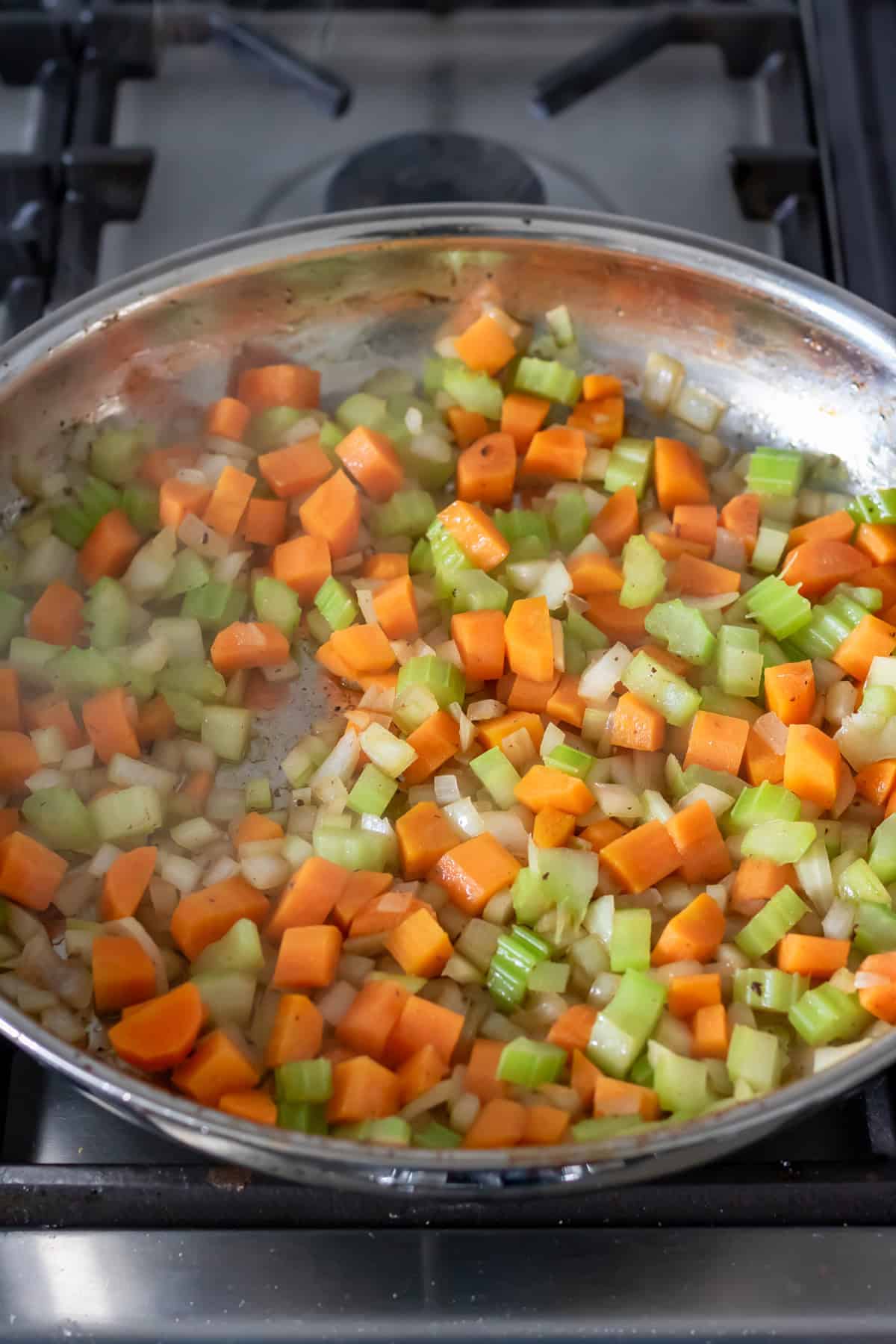 Cooking the soffritto - diced carrots, onions and celery - in the skillet.