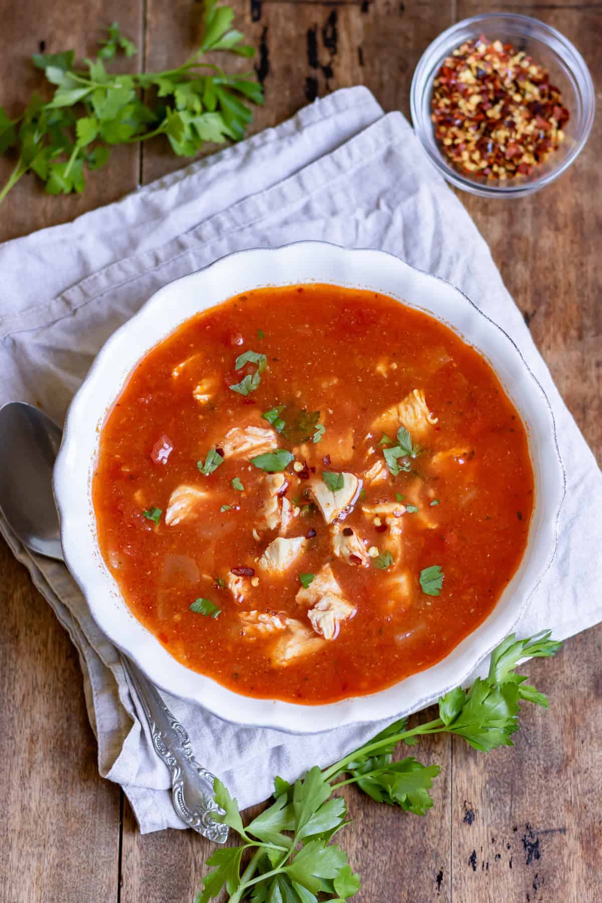 Looking down at a bowl of spicy chicken soup.