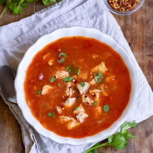 Looking down at a bowl of spicy chicken soup.