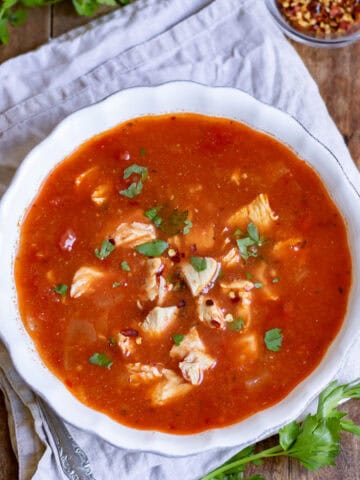 Looking down at a bowl of spicy chicken soup.