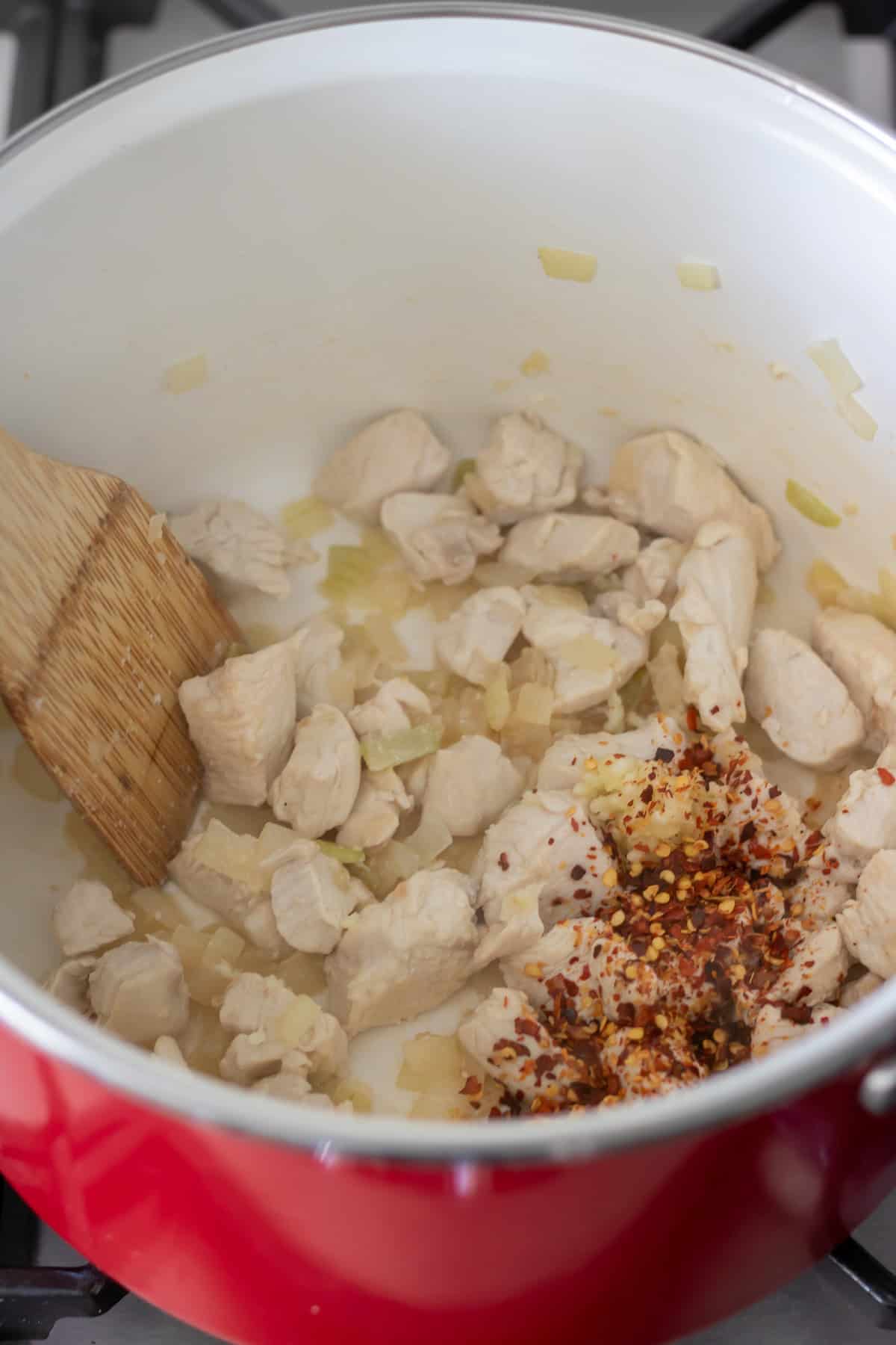 Stirring the chili flakes into the pot.